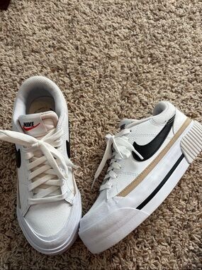 Nike White Low-Top Sneakers with Black Swoosh and Tan Stripe